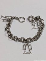 Front view of sterling silver charm bracelet with three angel charms and spring clasp