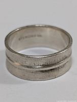 Front view of the sterling silver ring showing the textured double band design and size marking.