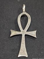 Front view of silver ankh pendant on dark background showing overall shape and condition.