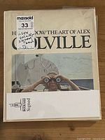 Book in protective plastic showing front cover artwork and handwritten MaxSold label