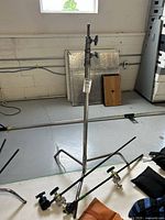 Full view of C-stand with two gobo arms and two grip heads arranged on floor