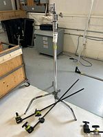 Avenger C-stand assembled with base, extension risers and grip head, gobo arms and clamps at base