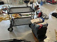 Equipment cart front and side view with apple boxes and supply boxes stacked