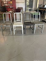 Front view of four chairs arranged in a row, showing color variations and overall condition