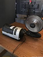 Photo showing Bravo coffee roaster and Noma heat radiator on wooden table.