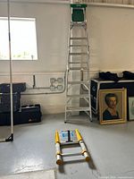 Showing both ladders in the room, one extended and one collapsed on the floor.