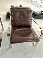 Front view of one chair showing leather cushion and chrome frame