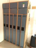 Front and side view of six compartment metal locker with blue doors and beige frame.