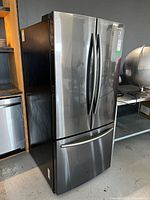 Angled front and left side view of refrigerator
