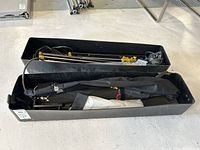 Overview of softbox carriers and light stands packed in black hard plastic containers.