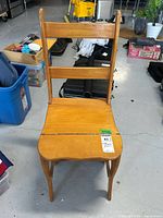 Front view of the vintage wooden step ladder chair showing the curved seat and backrest.