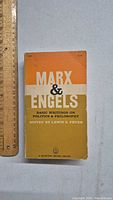 Front cover of the 1959 Marx & Engels Basic Writings book with orange, white, and yellow design.