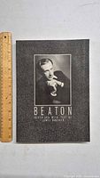 Cover of the Beaton photography book with portrait and textured black cover.