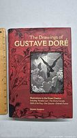 Front cover of 'The Drawings of Gustave Doré' art book showing artwork and title.