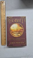 Front cover of The Hobbit two-part box set featuring title, author, and scenic illustration.