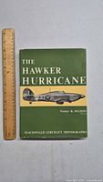 Front cover of the vintage book The Hawker Hurricane showing title, author, and aircraft illustration with ruler for scale.