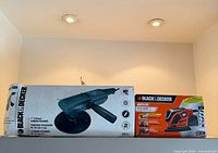 Black & Decker 7" Sander/Polisher box and Black & Decker Mouse Sander box side by side on a shelf.