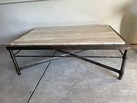 Front view showing entire coffee table, stone top and metal base