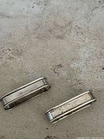 Photo showing two vintage sterling silver napkin rings placed on a textured surface. One ring inscribed with 'Dottie'.