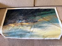 Full view of unframed large canvas art showing water, rocks, grass, and birds.