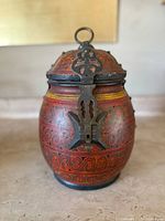 Front view of the vintage Moroccan painted wood lidded box showing detailed brass latch and floral scroll paintwork.