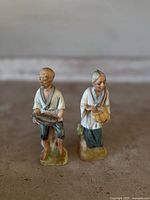 Front view of the Ardco bisque porcelain man and woman fishing figurines together showing detail and scale.