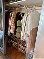 Closet rod with assorted hanging vintage garments in animal prints, sequined and lace jackets