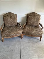Pair of Louis XV styled Bergere chairs with patterned brown upholstery and light wooden carved frames taken from front