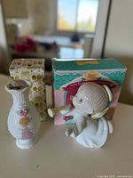 Photo showing the porcelain vase and boxed Christmas tree topper figurine from Precious Moments, with both original boxes visible