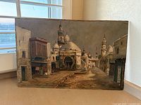 Full view of the vintage North African street scene painting showing the architectural details and signature area.