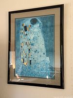 Clear view of the framed art print mounted on wall, showing the entire artwork in the black frame.