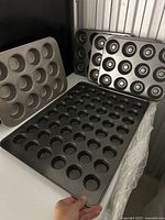 Overview of five baking pans arranged showing variety and condition.