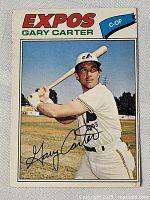 Front photo of the 1977 OPC Gary Carter Expos baseball card showing player in batting stance with autograph printed on the card.