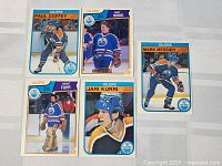 Five Edmonton Oilers hockey player cards showing Paul Coffey, Andy Moog, Grant Fuhr, Jari Kurri, Mark Messier