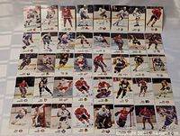 Photo of 34 1989 ESSO NHL hockey sticker cards featuring various players in team jerseys on ice