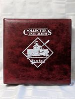 Front cover of dark brown Collector's Card Album with baseball graphics and 'Collector's Card Album Baseball' text.