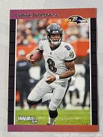 Front of 2019 Panini Donruss Lamar Jackson football card showing player in Ravens uniform running with football.