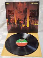 Vinyl LP record with label visible, laid out next to original cover