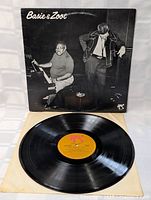 Vintage vinyl record LP with orange label, placed in a white paper inner sleeve, in front of the album cover showing Basie and Zoot in black and white photo