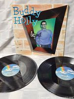 Front view of Buddy Holly Legend album cover with two vinyl discs on a white background.