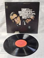 Photo showing front cover of 'Dave Brubeck's Jazz Greatest Hits' album and the vinyl record itself.