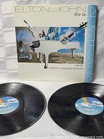 Front view of the Elton John Live in Australia album cover with both vinyl records placed in front.