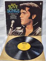 Front cover of the vinyl LP with Elvis Presley portrait and colorful 'Love Songs' title.