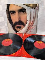 Front view of Sheik Yerbouti vinyl double LP set with album cover and two vinyl records visible