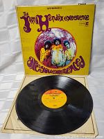 Front of vinyl album with yellow psychedelic cover and band photo in center circle.