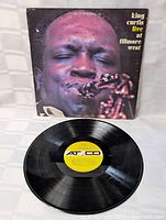 Vinyl record with yellow Atlantic label placed in front of original album cover showing King Curtis playing saxophone.
