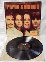Front view of Papas & Mamas vintage vinyl LP record partially out of album cover.