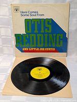 Vinyl LP record out of sleeve, showing bright yellow label and clean vinyl surface