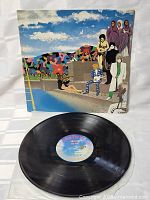 Close-up photo of vinyl record, showing the center label with text featuring artist and album title, verifying authenticity.