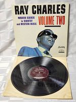 Vinyl record and cover showing front with Ray Charles image and album title in bold text